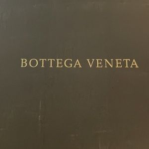 Bottega Veneta hobo style purse in dark, navy blue.